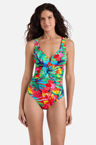 Woman wearing a multicolored palm leaf printed one-piece swimsuit