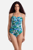 Woman wearing a blue and green floral printed bandeau tankini top