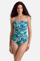Woman wearing a blue and green floral printed bandeau tankini top