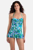 Woman wearing a blue and green floral printed skirted one-piece swimsuit
