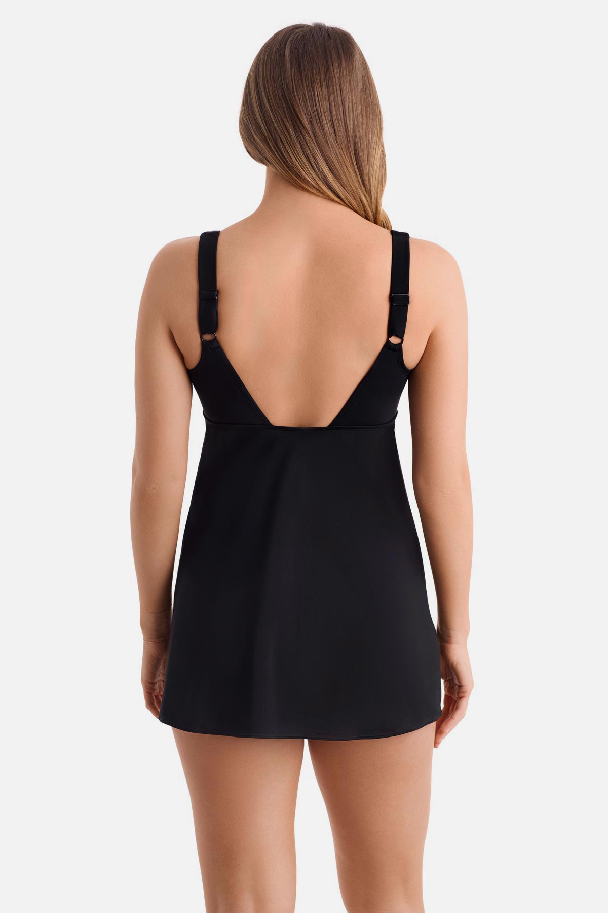 Woman turned away wearing a black and white swim dress