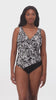 Woman wearing a black and white abstract printed one-piece swimsuit