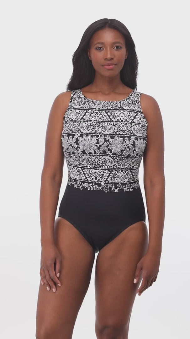 Woman wearing a black and white garland printed one-piece swimsuit