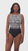 Woman wearing a black and white garland printed one-piece swimsuit