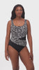 Woman wearing a black and white abstract printed one-piece swimsuit with mesh cutout on the side