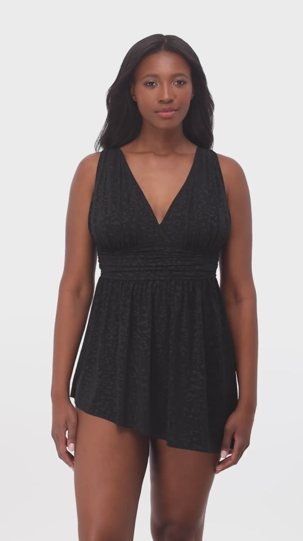 Woman wearing a black faint animal printed swim dress