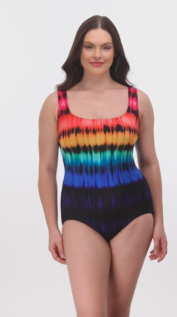 Woman wearing a rainbow tie dye one-piece swimsuit