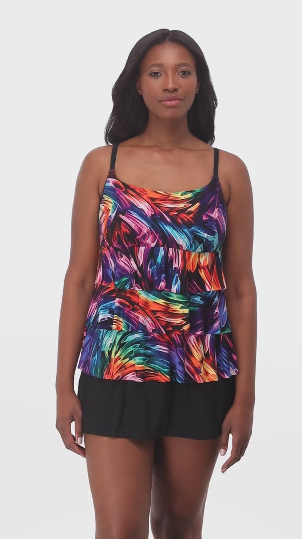 Woman wearing a rainbow ribbon printed ruffle skirtini swimsuit