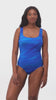 Woman wearing a blue streaked pattern one-piece swimsuit