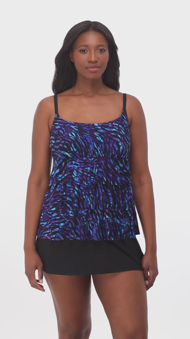 Woman wearing a black and blue safari printed ruffled skirtini swimsuit