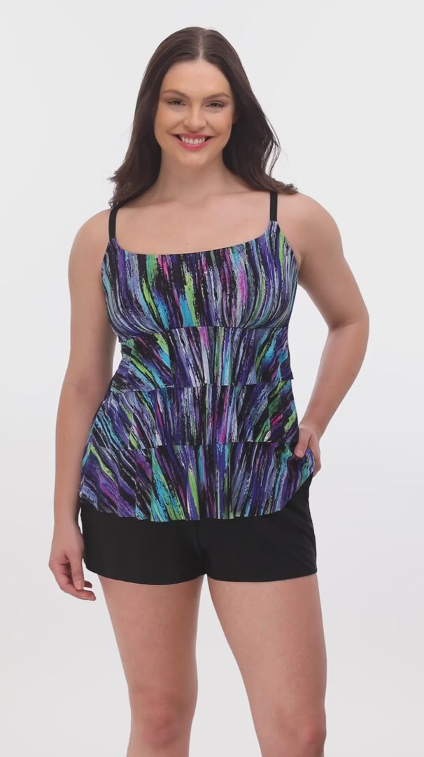 Woman wearing a multicolored streak printed ruffled swim shortini