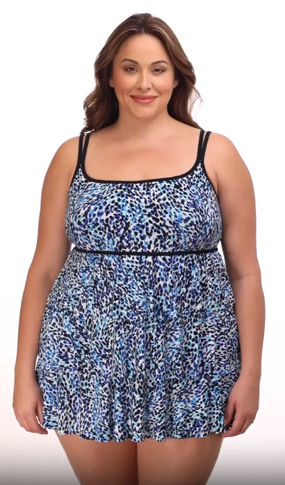 Woman wearing a multi-blue speckled swim dress with tiered ruffles