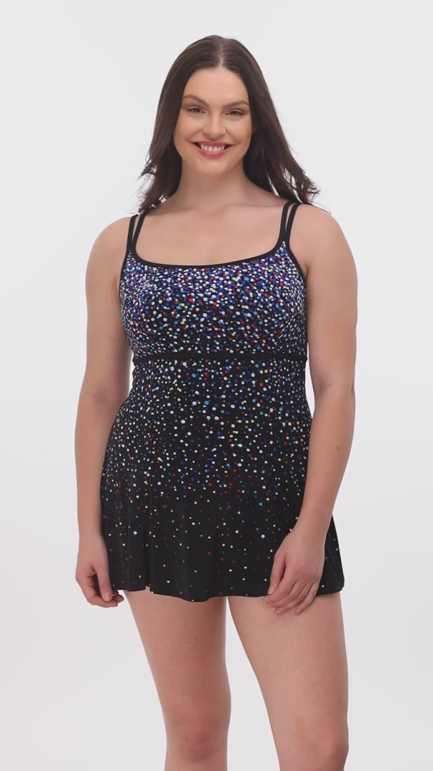 Woman wearing a multicolored dotted pattern swim dress