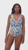 Woman wearing a brightly colored paisley print one-piece swimsuit