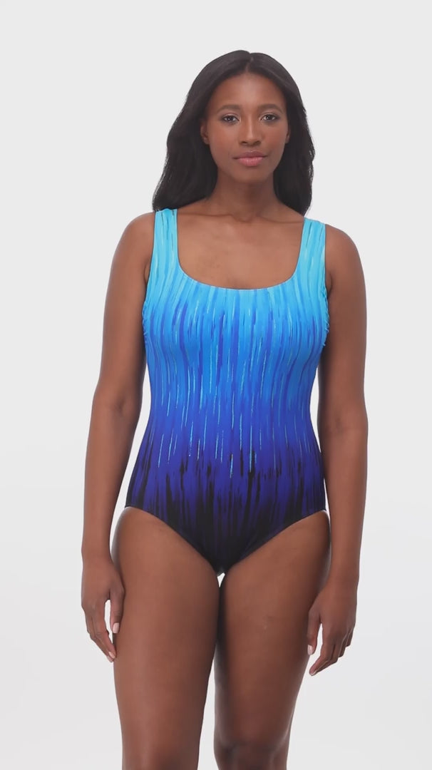 Woman wearing a blue ombre streaky pattern one piece swimsuit