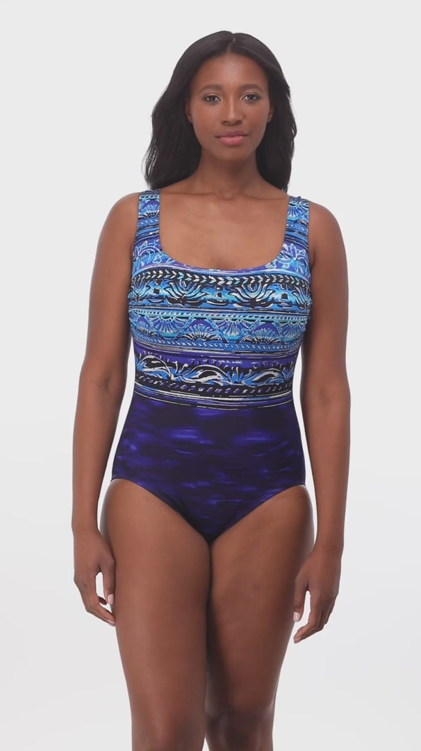 Woman wearing a blue abstract printed one-piece swimsuit