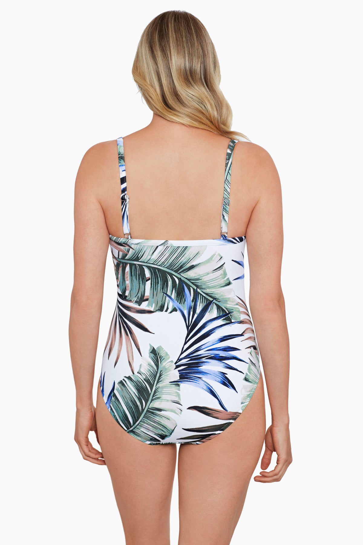 Woman faced away wearing a multicolored palm leaf printed one-piece swimsuit