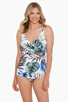 Woman wearing a multicolored palm leaf printed one-piece swimsuit