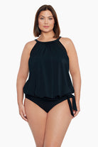 Woman wearing a black high neck blouson tankini top