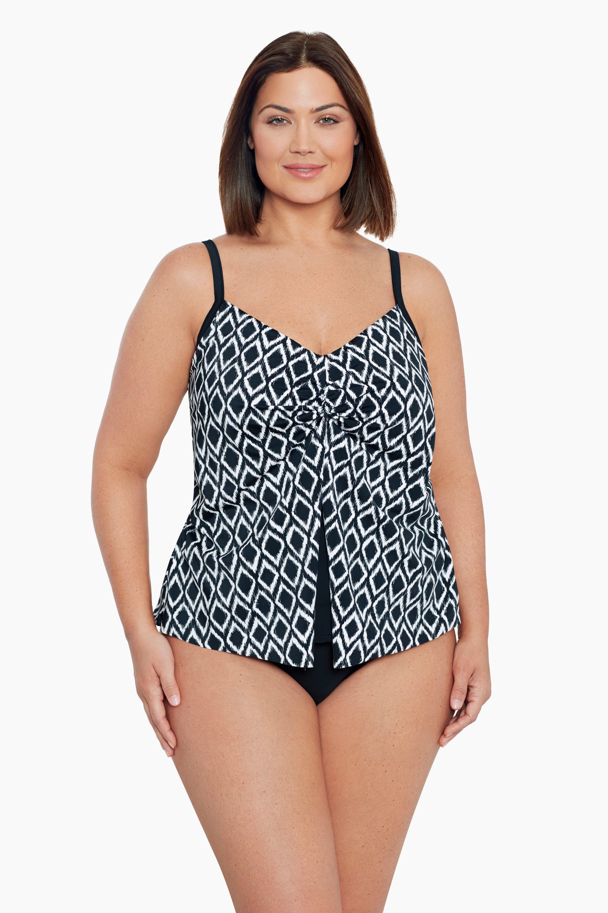 Woman wearing a black and white diamond pattern middle split tankini top
