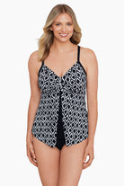 Woman wearing a black and white diamond printed cut away tankini top