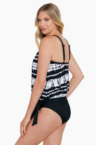 Woman turned left wearing a black and white tie dyed blouson with mesh detail tankini top