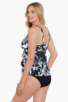 Woman wearing a black and white floral pattern triple tier tankini top