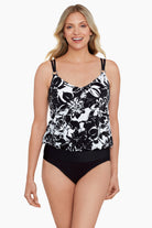 Woman wearing a black and white floral pattern blouson ring tankini top