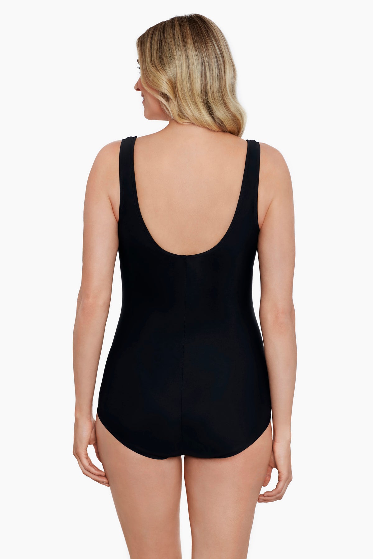 Woman turned away wearing a blue tile-esque printed one-piece swimsuit