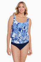 Woman wearing a blue and white tropical printed blouson tankini top