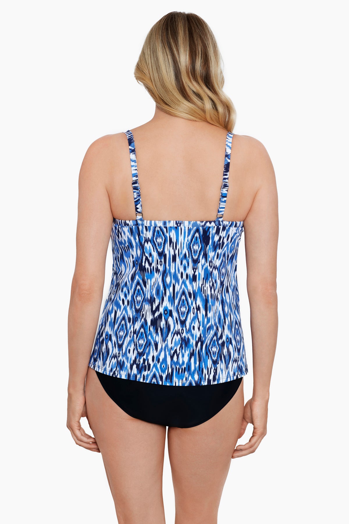 Woman turned away wearing a blue and white abstract printed cut away fauxkini one-piece swimsuit