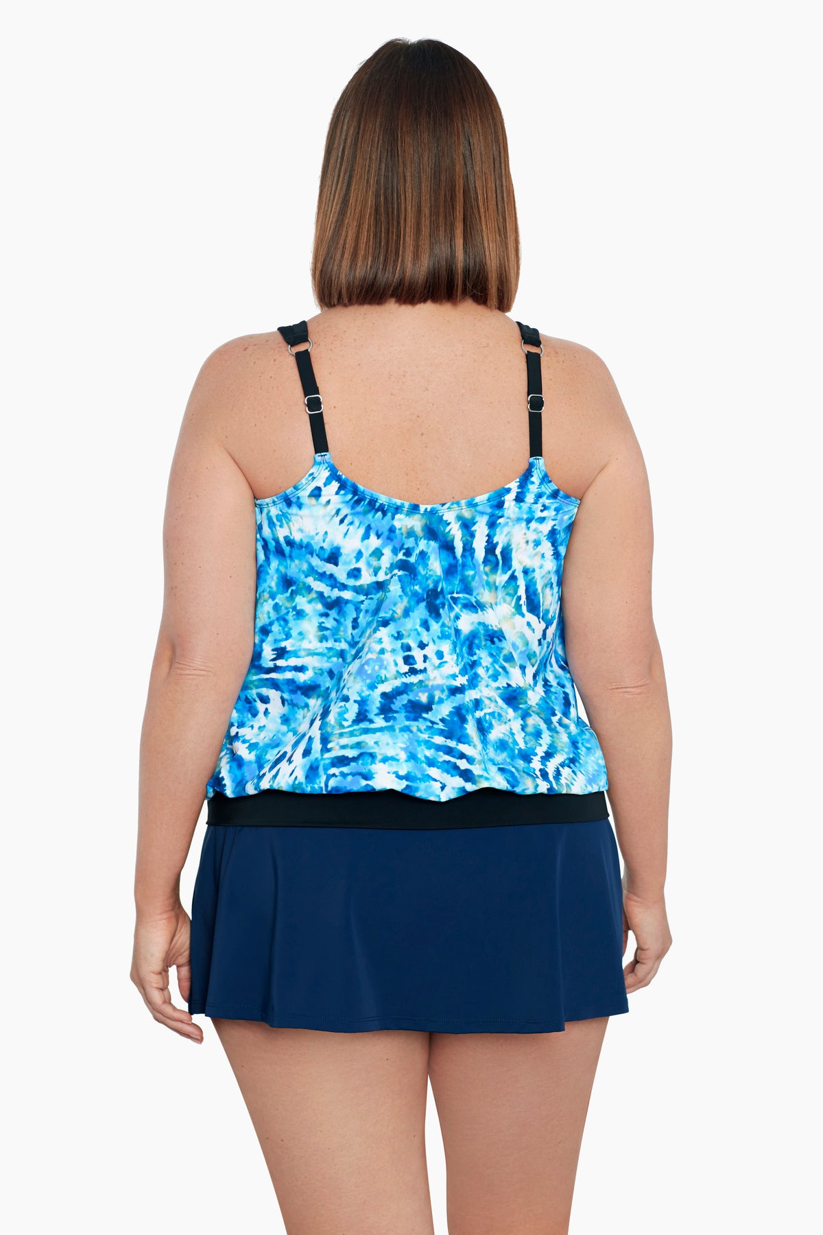 Woman faced away wearing a blue and white tie dye blouson tankini top