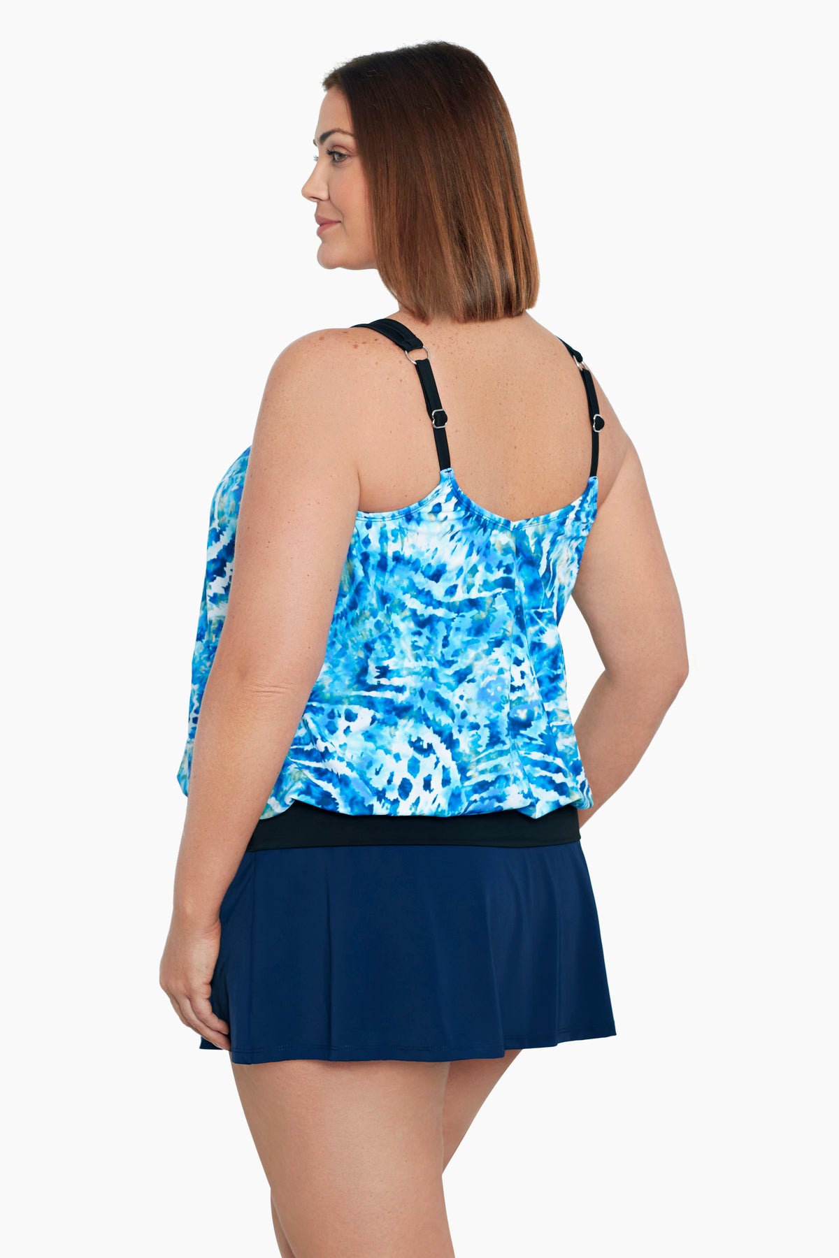 Woman turned left wearing a blue and white tie dye blouson tankini top