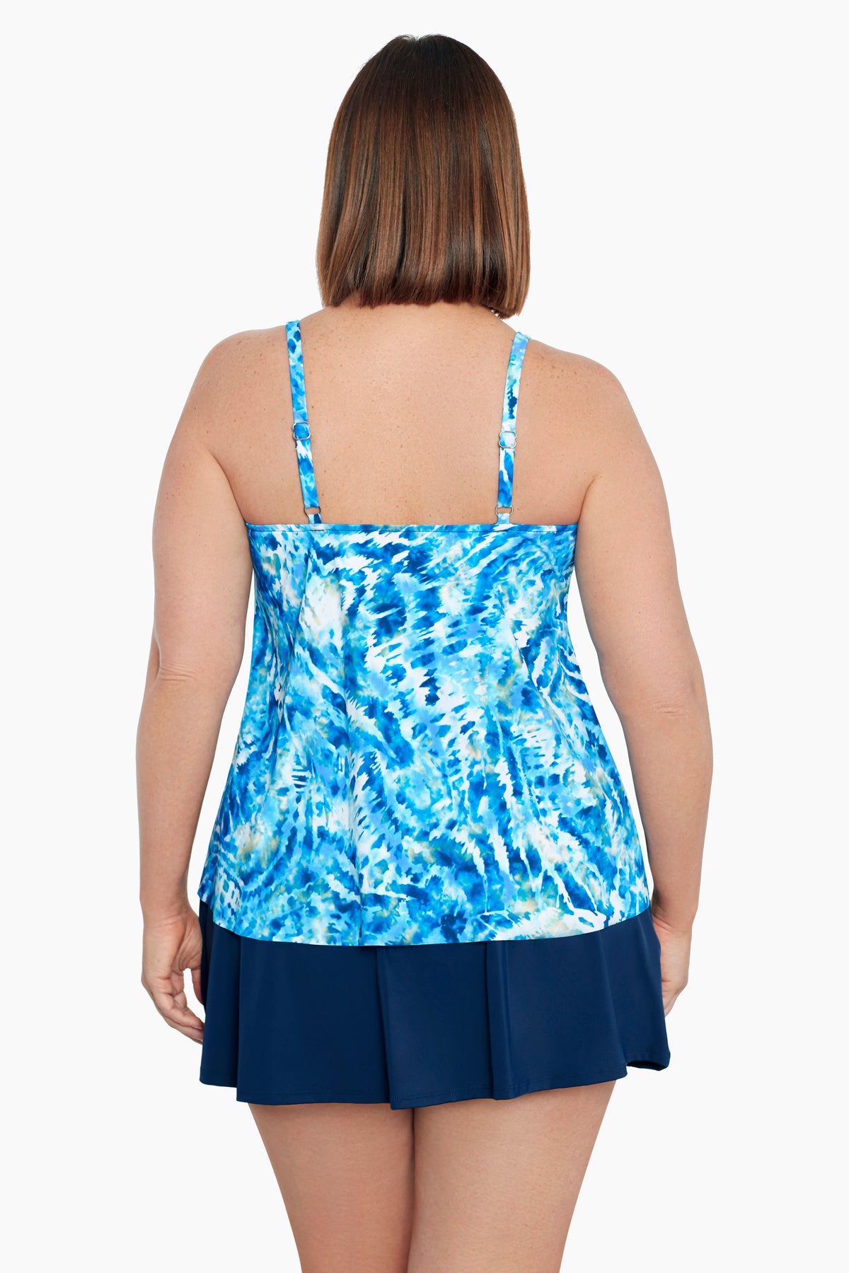 Woman faced away wearing a blue and white tie dye side O ring tankini top