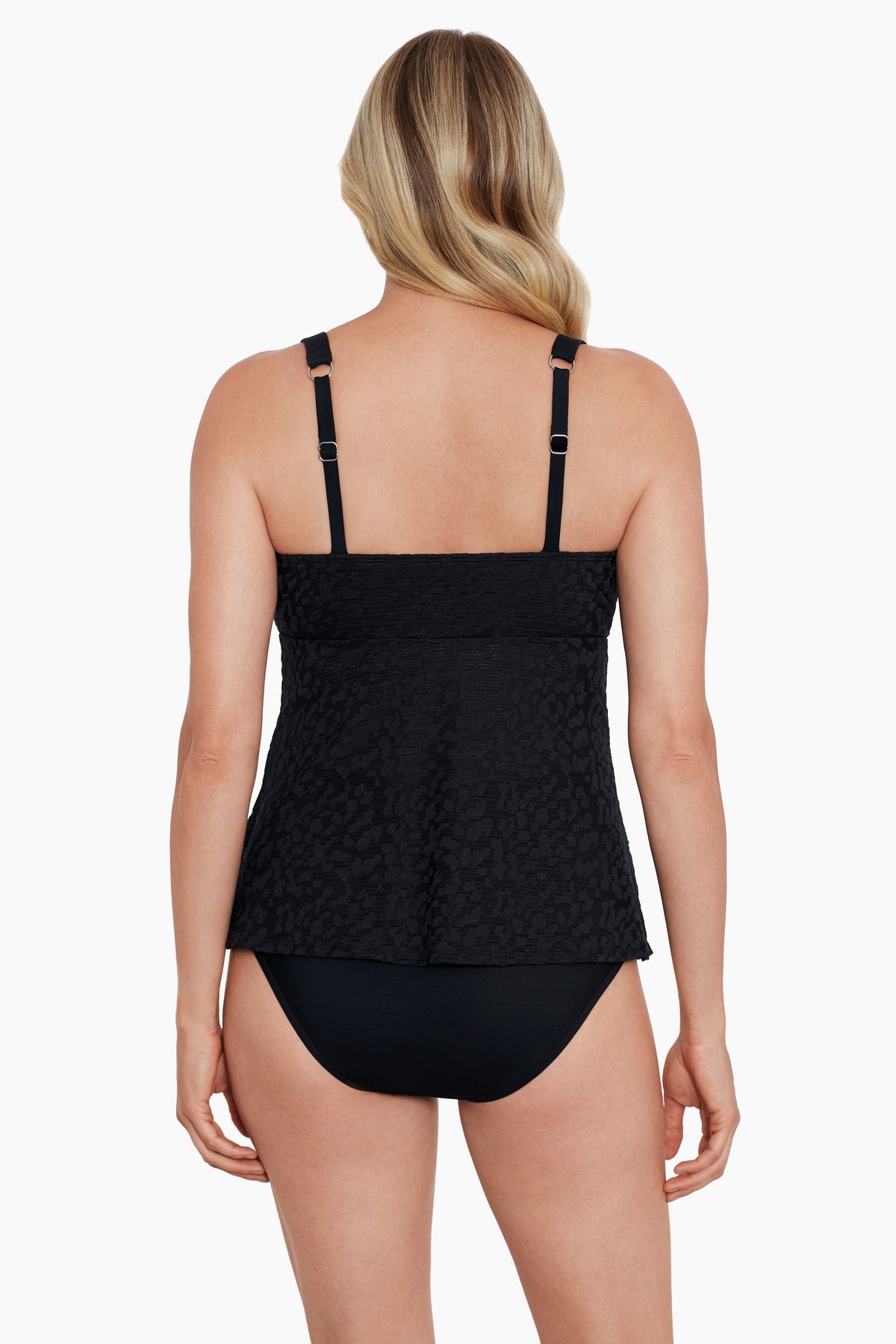 Woman turned away wearing a black with light animal print triple tier tankini top