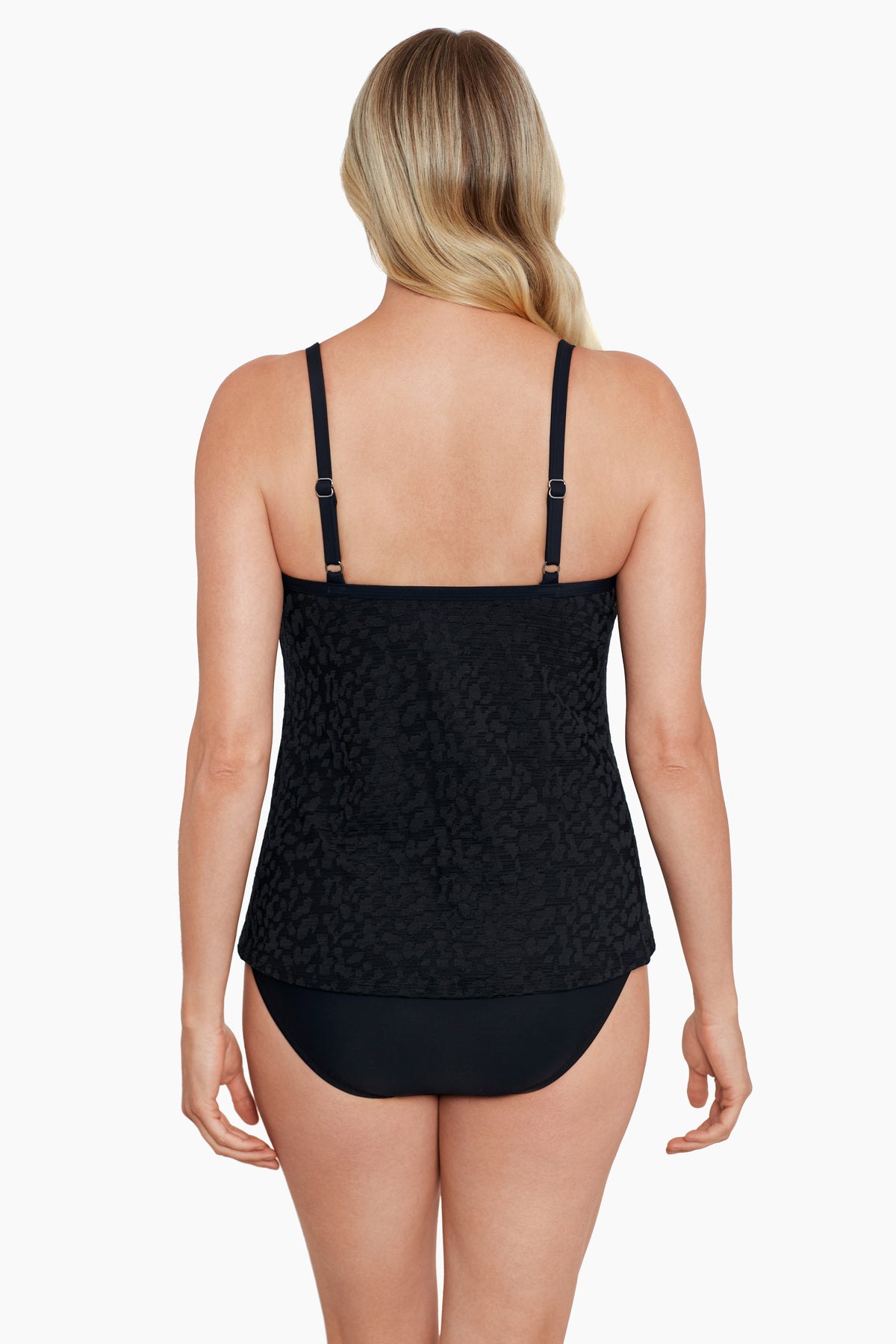 Woman faced away wearing a black with light animal print cut away fauxkini one-piece swimsuit