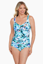 Woman wearing a multicolored floral printed one-piece swimsuit