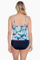 Woman turned away wearing a multicolored floral printed V neckline one-piece swimsuit