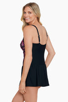Woman turned left wearing a pink dotted pattern square neck skater swim dress