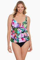 Woman wearing a tropical printed tiered ruffle tankini top 