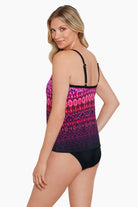 Woman turned left wearing a pink ombre and tile printed tankini top