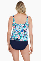 Woman turned away wearing a multicolored floral tankini top