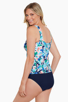 Woman turned left wearing a multicolored floral tankini top
