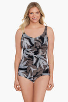 Woman wearing a dotted leaf pattern one-piece swimsuit