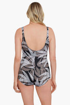 Woman turned away wearing a dotted leaf pattern one-piece swimsuit