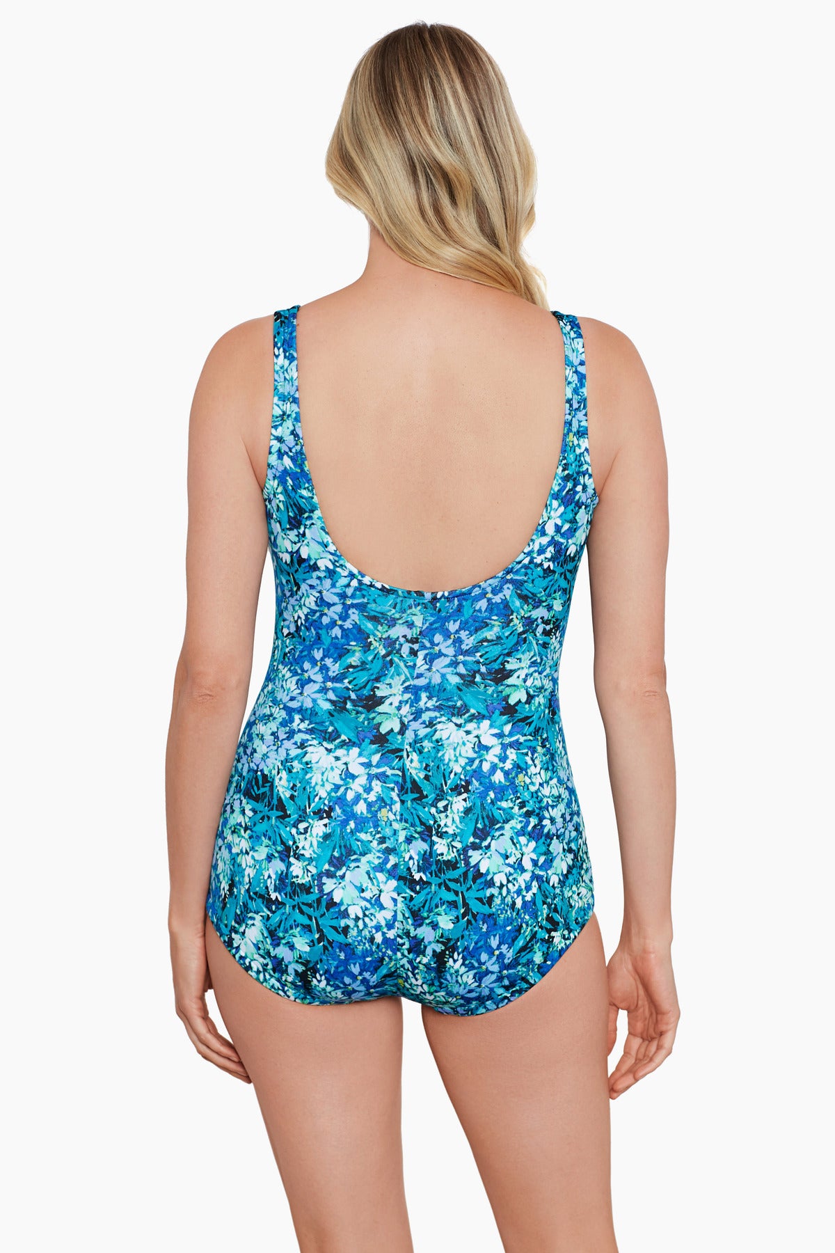 Woman faced away wearing a small blue floral printed one-piece swimsuit