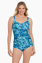Woman wearing a small blue floral printed one-piece swimsuit