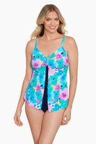 Woman wearing a blue and pink floral printed cut away tankini top