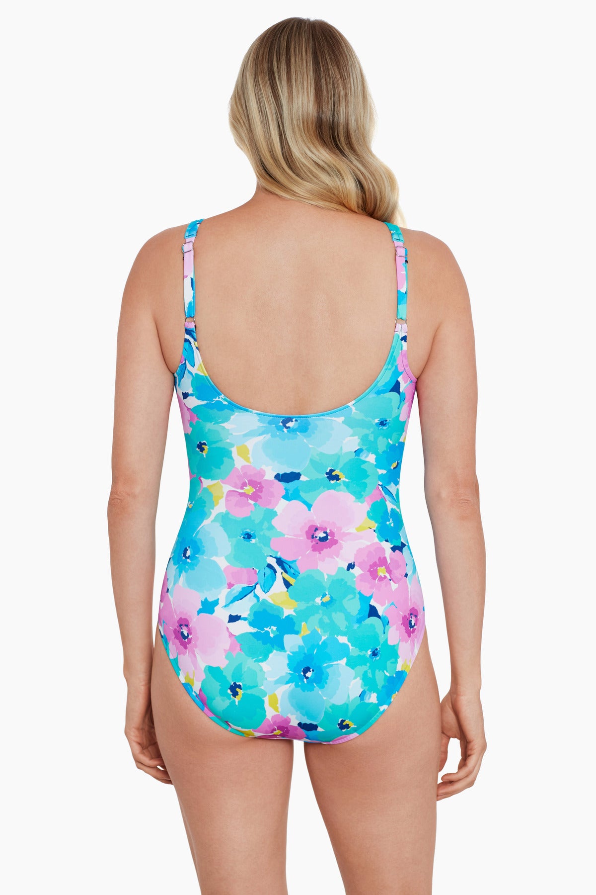 Woman turned away wearing a blue and pink floral printed one-piece swimsuit