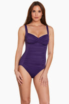 Woman wearing a purple one-piece swimsuit 